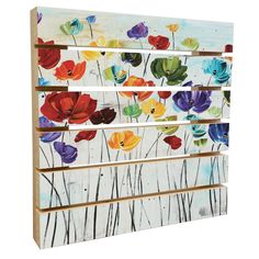 an art piece with colorful flowers painted on the side of it and wooden slats