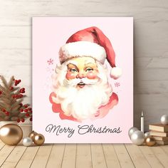 a christmas card with a santa clause on it next to some ornaments and a potted plant