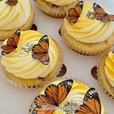 cupcakes with yellow frosting and butterflies on them