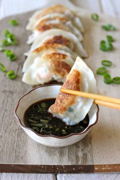 some food is in a small bowl with chopsticks