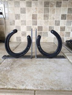 a pair of horseshoes sitting on top of a kitchen counter next to a tile backsplash