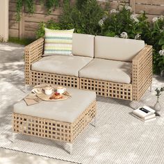 a wicker couch and coffee table on a patio