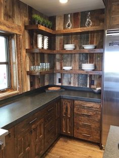 a kitchen with wooden cabinets and black counter tops