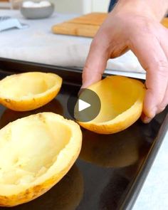 someone is peeling an uncooked melon on a baking sheet in the kitchen