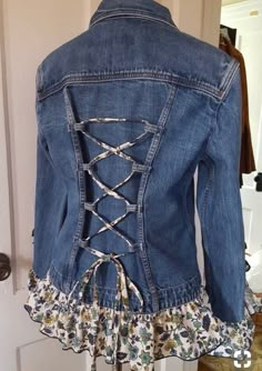 a denim jacket with laces on the back