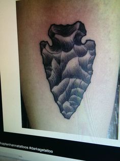 a black and white photo of a heart tattoo