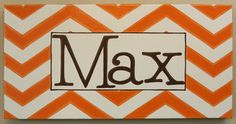 an orange and white chevroned canvas with the word max in black on it