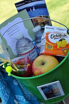 a green bucket filled with food and drinks