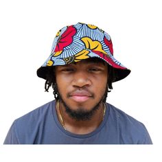 A unisex bucket cap made using authentic Ankara fabric. 58cm. Ankara, also known as African wax print or Dutch wax print, is a fabric characterized by vibrant patterns and colors. The fabric is made through a wax-resist dyeing technique called batik which creates distinct and colorful patterns. Ankara fabric is used to make a wide range of clothing and accessories, including dresses, skirts, shirts, and hats. Each pattern carries cultural meanings and stories making pieces made from this fabric not just fashion items but also carriers of African heritage and identity. Multicolor Reversible Cotton Bucket Hat, Reversible Multicolor Cotton Bucket Hat, Multicolor Reversible Cotton Sun Hat, Reversible Multicolor Cotton Sun Hat, Casual Multicolor Cotton Bucket Hat, Large Framed Artwork, Dutch Wax Print, Raffia Sun Hat, Resist Dyeing