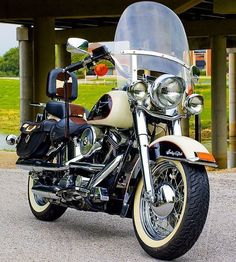 a motorcycle parked in front of a building with a helmet on it's back end