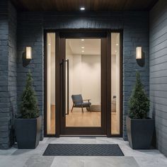 an entry way with two planters and a chair