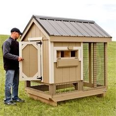 a man standing next to a chicken coop