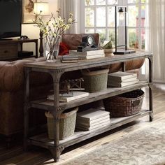 a living room filled with furniture and lots of books on top of a wooden table