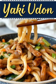 a bowl filled with noodles and meat on top of a blue plate next to chopsticks