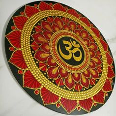 a decorative plate with an om symbol painted on it