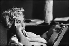 a black and white photo of a woman sitting in a chair