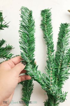 someone is making fake pine branches out of plastic