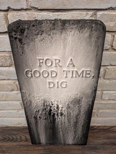 a tombstone with the words for a good time, dig on it's side