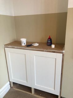 a white cabinet with some paint on it