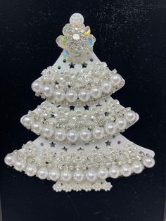 a white christmas tree made out of pearls