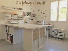 a large white kitchen with lots of drawers and counter space in front of the window