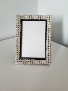 a white and black frame sitting on top of a table