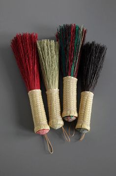 three different types of brooms on a gray background