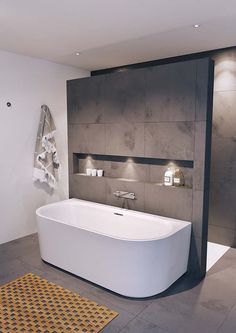 a large white bath tub sitting inside of a bathroom