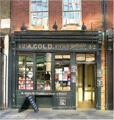 an old fashioned store front on a city street