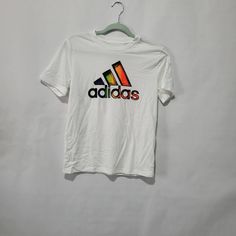 Nwt Adidas Kids White T-Shirt Size 10-12 Retail Price $20.00 White Adidas Logo Crew Neck T-shirt, White Adidas Graphic Tee, White Adidas Graphic Tee With Logo, Adidas White Crew Neck T-shirt, White Adidas Shirt With Letter Print, White Adidas Crew Neck T-shirt, White Cotton Adidas Logo Tops, Basic Adidas T-shirt With Graphic Print, Adidas Multicolor Crew Neck T-shirt