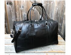 The Tourist Leather Weekender Bag - A classic zip-top leather duffel for both men and women. Use it for a mini vacation, gym or for just running around town; this leather travel bag will certainly be turning heads. One large inside zipper compartment for accessories or toiletries, this is your go to carry machine. FREE ENGRAVING Lifetime warranty 100% handcrafted No artificial, synthetic, or cardboard used Made with the premium and most durable form of leather: full grain cowhide leather Designed in Canada Sturdy YKK zipper Airline carry-on friendly Heavy duty cotton lining inside Interior features 2 wide compartments on each side with zipper closure Exterior features one open pocket Exterior features one zipper pocket Adjustable, removable leather shoulder strap Brass feet on the bottom t Elegant Black Duffle Bag For Weekend Trips, Classic Black Luggage For Weekend Trips, Elegant Black Weekender Bag For Overnight Trips, Black Bags With Leather Backing For Business Trips, Classic Black Duffle Bag For Overnight Trips, Black Leather Luggage For Overnight Trips, Black Weekender Bag With Leather Lining For Overnight Trips, Black Leather-lined Weekender Bag For Overnight Trips, Classic Black Bag For Overnight Trips