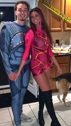 a man and woman dressed up as superman and catwoman pose for a photo in the kitchen