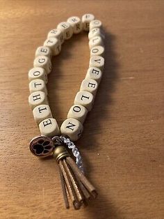 a bracelet with keys and words on it