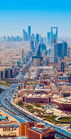 an aerial view of a large city with lots of tall buildings and roads in the foreground