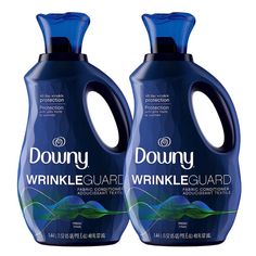 two bottles of downy wrinkleguard liquid on a white background, one is blue and the other is green