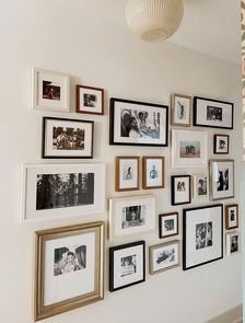 a wall full of pictures and framed photographs