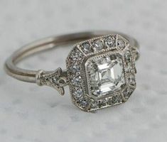 an engagement ring with a square cut diamond in the center