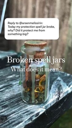 a jar filled with coins sitting on top of a wooden table