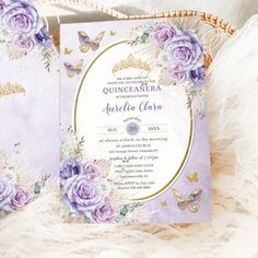 the wedding card is decorated with purple roses