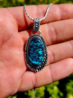 This 100% handmade pendant is made from a beautiful self cut and polished Chrysocolla specimen, and has been crafted into a custom one of a kind 925 silver setting that you won't find anywhere else. The visual with a deep blue that looks at the bottom of the sea is like a universe. It is a power stone that attracts what you see. Chrysocolla is a stone that is strong in calmness and sustainability, and has a lot of energy for healing. It removes all the negative power surrounding the owner and brings you positive energy. The pendants height (not including the bail) is 34.5mm and the width is 21mm at its widest point.  If you have any questions or other inquiries, please feel free to message me through the app. Handmade Chrysocolla Oval Pendant Jewelry, Handmade Oval Pendant With Gemstone, Silver Chrysocolla Cabochon Necklace, Chrysocolla Large Pendant Jewelry Gift, Chrysocolla Large Pendant Jewelry For Gift, Silver Chrysocolla Necklace With Large Stone, Handmade Sterling Silver Turquoise Necklace With Oval Pendant, Handmade Turquoise Necklace With Oval Sterling Silver Pendant, Collectible Sterling Silver Turquoise Gemstone Necklace