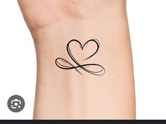 a small heart tattoo on the wrist with an arrow in the shape of a heart