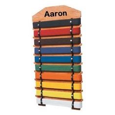 an image of a rack with various colors of belts on it and the name aaron