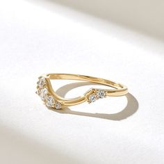 This gorgeous, unique wedding ring showcases ethically sourced natural diamonds.  Made to order in your choice of 10K, 14K, or 18K gold in rose, yellow, or white, this elegant band boasts a 0.25ctw D-E-F color, VVS clarity diamond.  With a 1.14mm width and 0.90mm thickness, it's ready to ship in 5-7 business days.  We're committed to sustainability, using recycled gold and post-consumer materials for our jewelry. Wedding Bands For Pear Cut Rings, Curved Wedding Ring Stack, Asymmetrical Diamond Ring, Asymmetrical Ring, Contour Ring, Wedding Ring Shapes, Half Bezel, Ring Enhancer