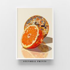 an orange cut in half sitting on top of a white surface with the words stendral prints underneath it