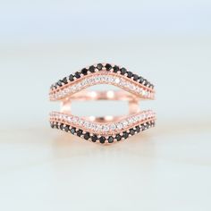 two black and white diamond wedding bands in rose gold, set on top of each other