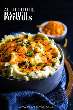 mashed potatoes with cheese and green onions in a bowl