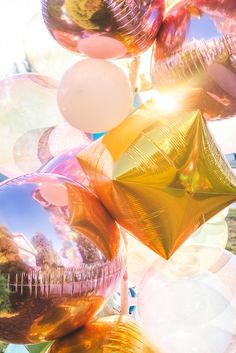 many shiny balloons are floating in the air