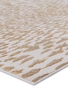 a beige and white area rug with sand patterns on the bottom, in front of a white background