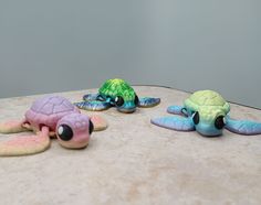 three small turtle figurines sitting on top of a table