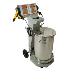 a machine that is sitting on top of a metal barrel with an orange light in the middle